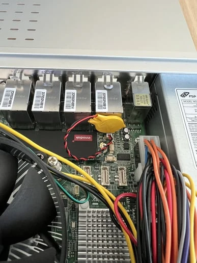 The new yellow battery plugged into the motherboard